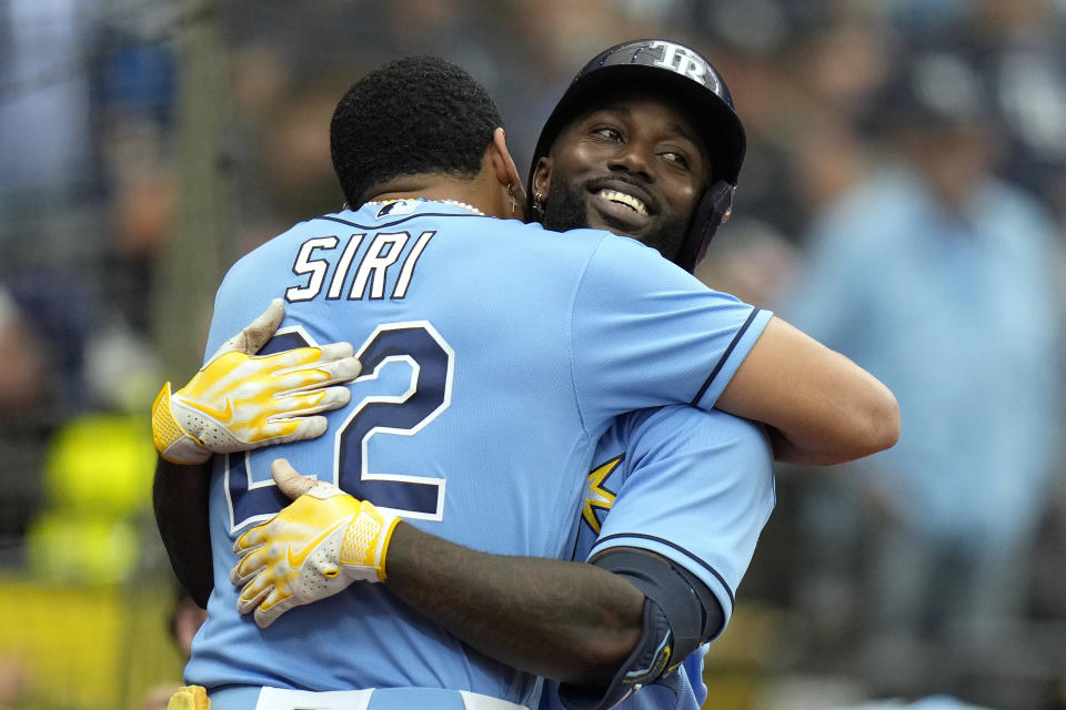 Tampa Bay Rays' Randy Arozarena hugs Jose Siri (22) after Arozarena hit a solo home run off Detroit Tigers starting pitcher Joey Wentz during the fourth inning of a baseball game Sunday, April 2, 2023, in St. Petersburg, Fla. (AP Photo/Chris O'Meara)