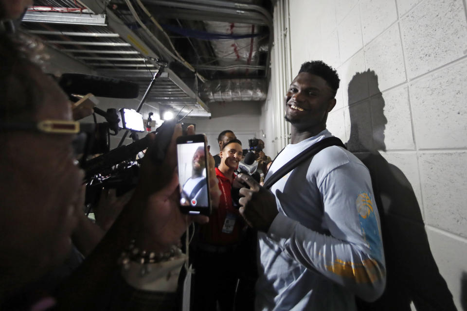 New Orleans Pelicans rookie forward Zion Williamson (1) is interviewed in a hallway after defeating the Atlanta Hawks in a preseason NBA basketball game Monday, Oct. 7, 2019, in Atlanta. (AP Photo/John Bazemore)