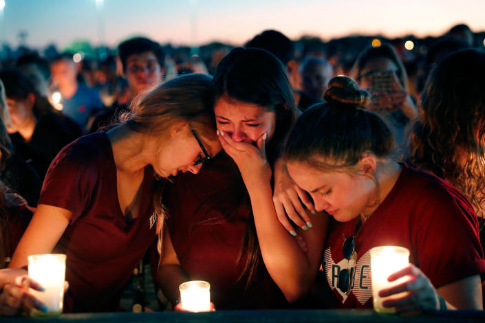 <p>Students console each other as they weep during a candlelight vigil for the victims of the Wednesday shooting at Marjory Stoneman Douglas High School, in Parkland, Fla., Thursday, Feb. 15, 2018. (Photo: Gerald Herbert/AP) </p>