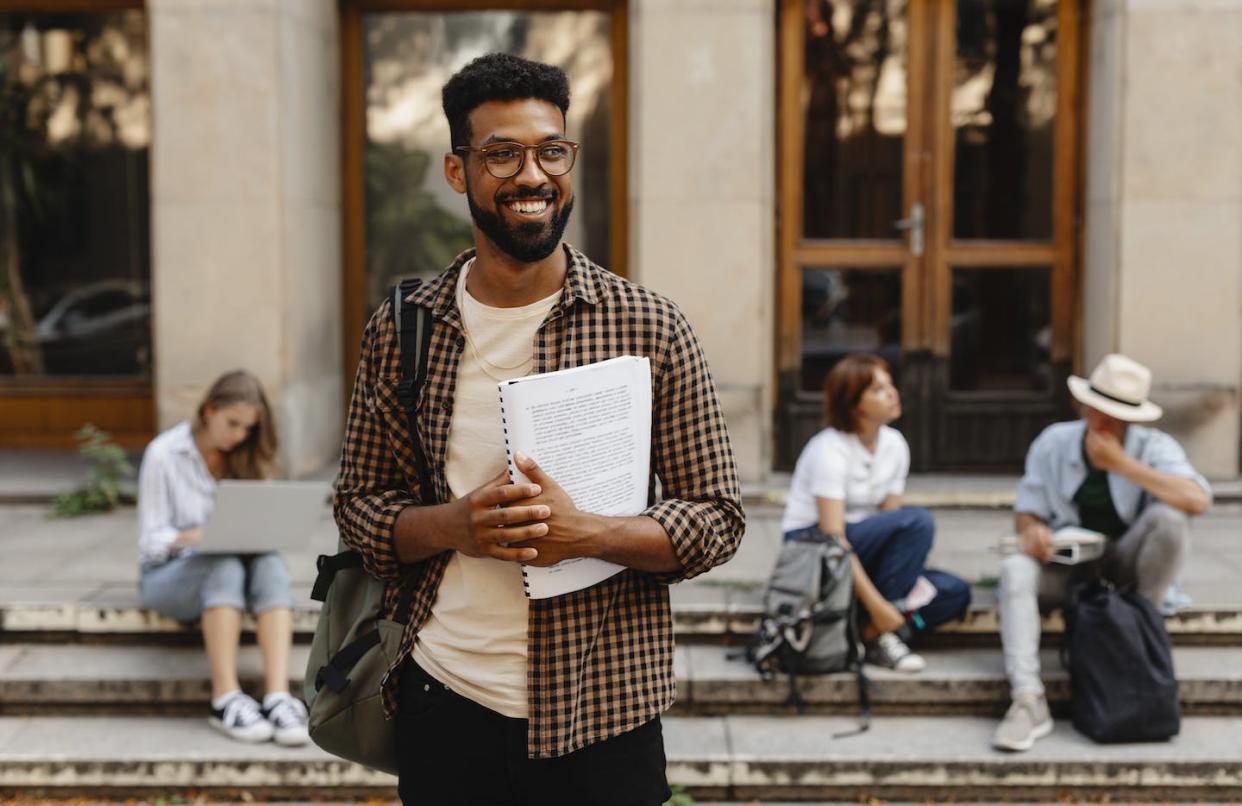 Black students reported stress as a result of trying to downplay their cultural identities. <a href="https://www.gettyimages.com/detail/photo/happy-young-university-student-with-book-standing-royalty-free-image/1340017268?phrase=black%20college%20students&adppopup=true" rel="nofollow noopener" target="_blank" data-ylk="slk:Halfpoint Images;elm:context_link;itc:0;sec:content-canvas" class="link ">Halfpoint Images</a>