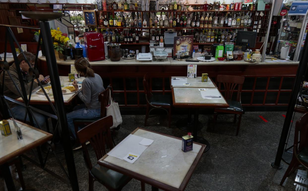 Patrons enjoy lunch at a bar reopened after the easing of quarantine measures on July 6, 2020, in Sao Paulo, Brazil. The city of Sao Paulo eased restrictions on bars, restaurants and beauty salons amidst the coronavirus pandemic.