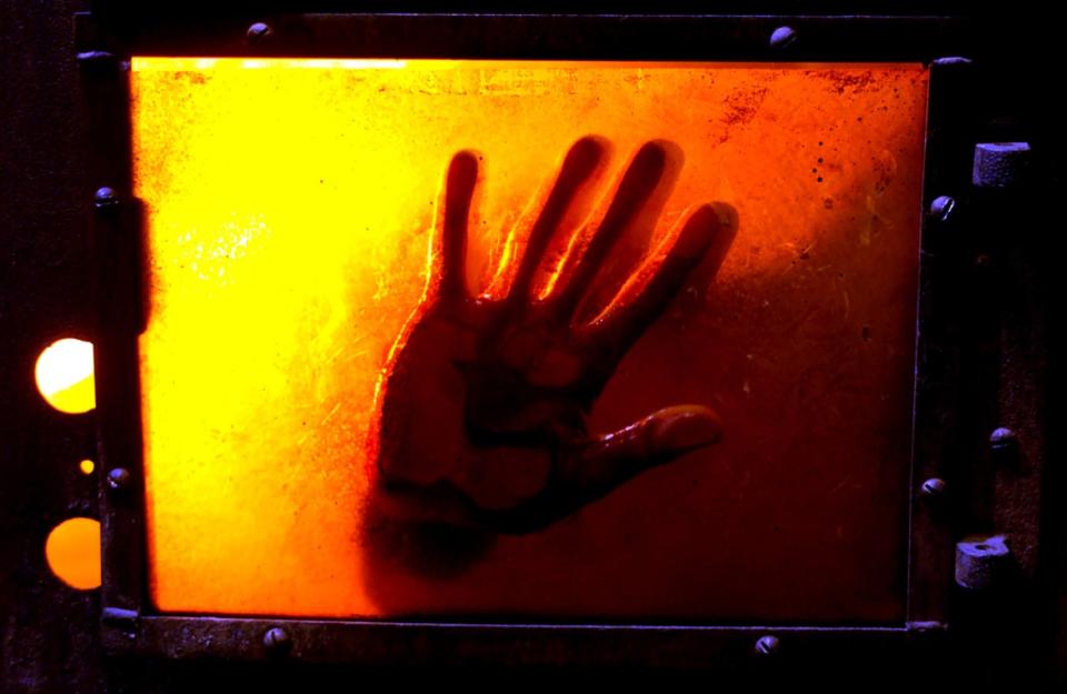A hand up against a furnace in Saw II