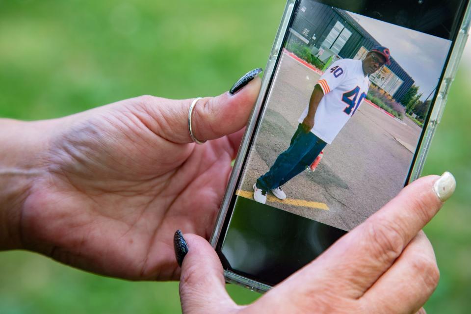 Sara Jones holds her phone with a photo of her late husband Kenneth on Friday, July 17, 2020.