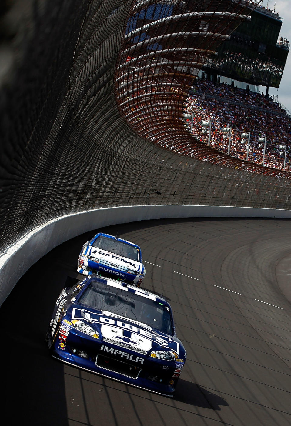 BROOKLYN, MI - JUNE 17: Jimmie Johnson, driver of the #48 Lowe's Chevrolet, leads Carl Edwards, driver of the #99 Fastenal Ford, during the NASCAR Sprint Cup Series Quicken Loans 400 at Michigan International Speedway on June 17, 2012 in Brooklyn, Michigan. (Photo by Jeff Zelevansky/Getty Images)