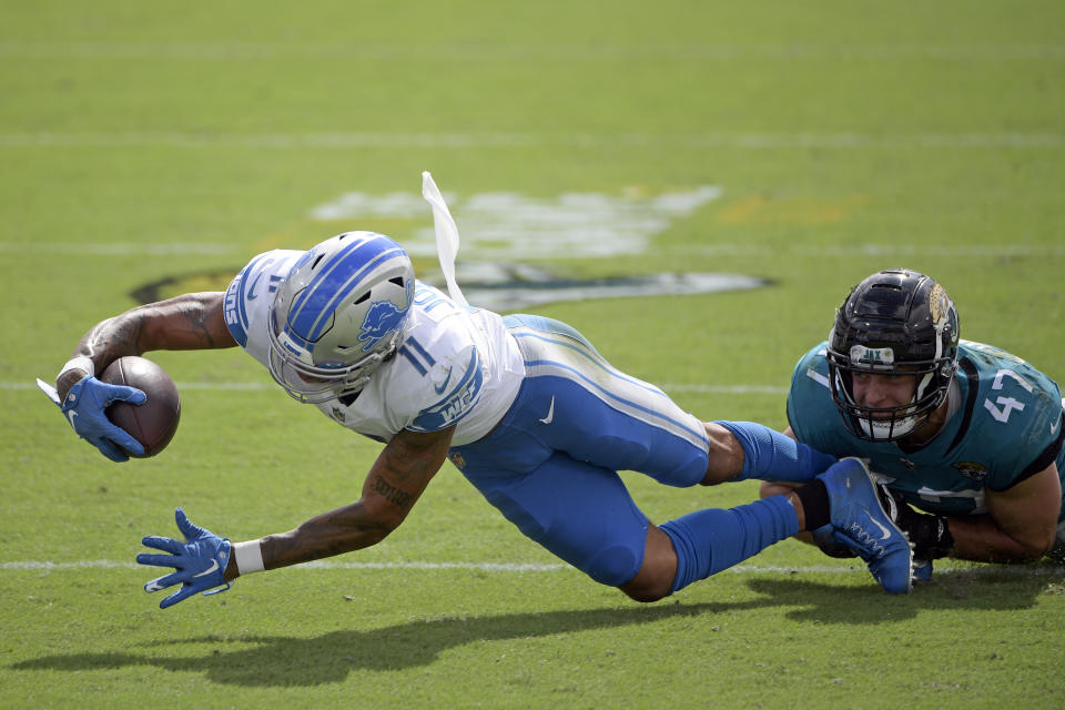 Detroit Lions wide receiver Marvin Jones Jr. (11) is stopped by Jacksonville Jaguars linebacker Joe Schobert (47) after a reception during the first half of an NFL football game, Sunday, Oct. 18, 2020, in Jacksonville, Fla. (AP Photo/Phelan M. Ebenhack)