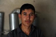 Unemployed Afghan Saber Rezayee is pictured at his family's heater shop in Mazar-i-Sharif on September 20, 2013