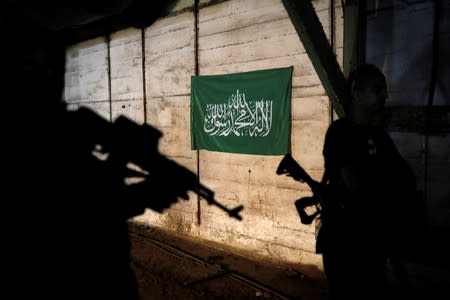 Actors are silhouetted next to a Hamas flag, on the set of Israeli television series "Fauda" in Tel Aviv