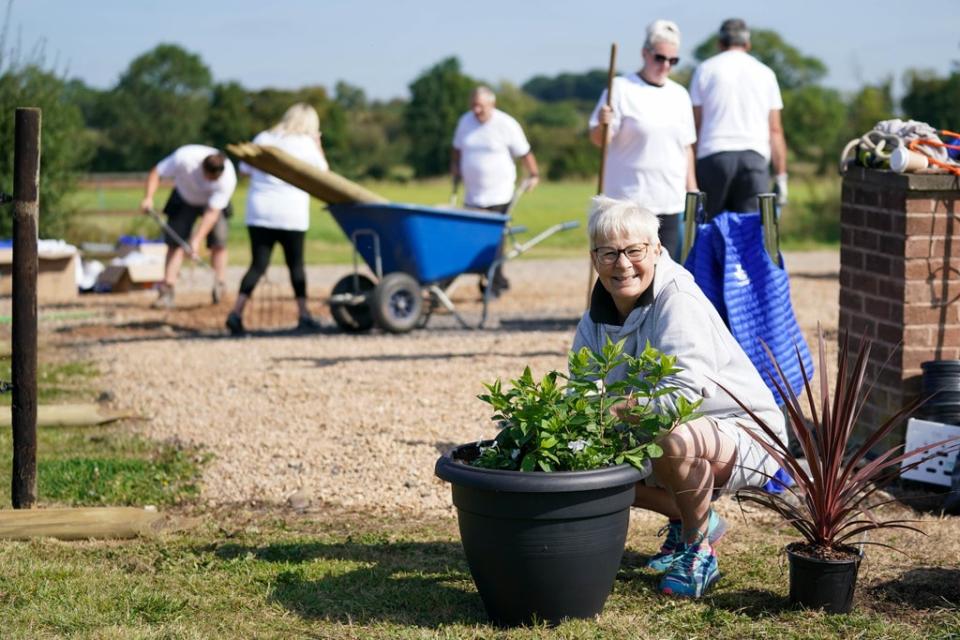 Terri Picton-Clark and other lottery winners help transform the yard at The Way of The Horse, in Lutterworth, Leicestershire (Jacob King/PA) (PA Wire)