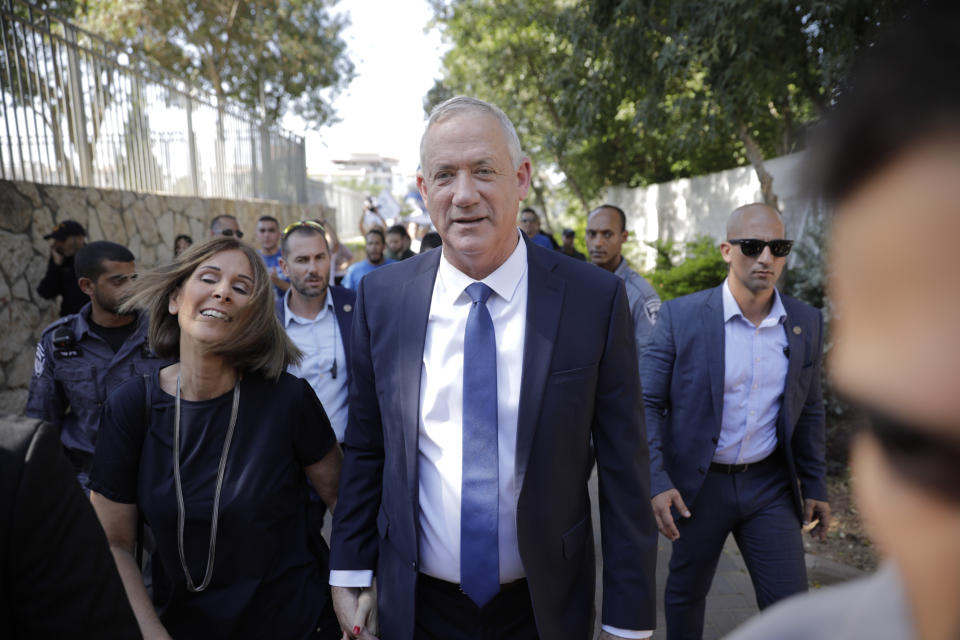 Blue and White party leader Benny Gantz and his wife Revital leave polling station in Rosh Haayin, Israel, Tuesday, Sept. 17, 2019. Israelis began voting Tuesday in an unprecedented repeat election that will decide whether longtime Prime Minister Benjamin Netanyahu stays in power despite a looming indictment on corruption charges. (AP Photo/Sebastian Scheiner)