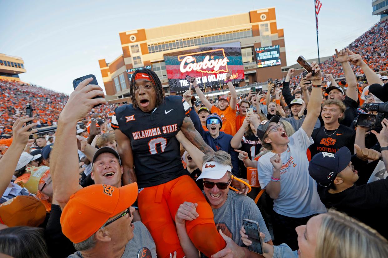 Oklahoma State Cowboys running back Ollie Gordon II (0) celebrates with fans after a Bedlam college football game between the Oklahoma State University Cowboys (OSU) and the University of Oklahoma Sooners (OU) at Boone Pickens Stadium in Stillwater, Okla., Saturday, Nov. 4, 2023. Oklahoma State won 27-24.