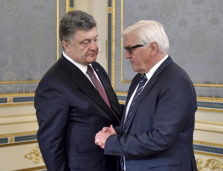 A picture taken and released by the Ukrainian presidential press-service shows the President Poroshenko (L) welcoming German Foreign Minister Frank-Walter Steinmeier prior the talks in Kiev on May 29, 2015