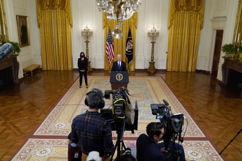 Vice President Kamala Harris, left, listens as President Joe Biden speaks about the economy, in the East Room of the White House, Monday, May 10, 2021, in Washington. (AP Photo/Evan Vucci)