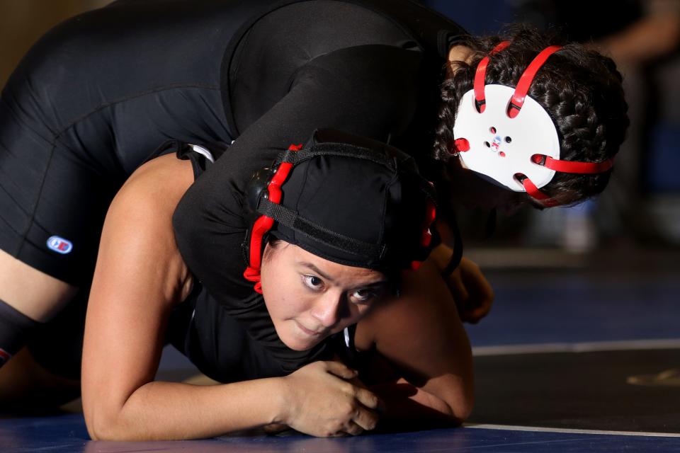 Stefany Morales (top, not shown), a student at International High School and a wrestler on the John F. Kennedy High School Wrestling Team, takes on Katlyn Juarez, of Passaic County Technical Institute, in Wayne.  Wednesday, January 19, 2022