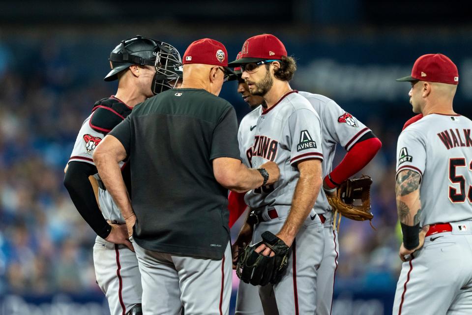 Arizona Diamondbacks pitching coach Brent Strom (72) comes out to the mound to talk to Arizona Diamondbacks starting pitcher Zac Gallen (23) during the second inning at Rogers Centre in Toronto on July 15, 2023.