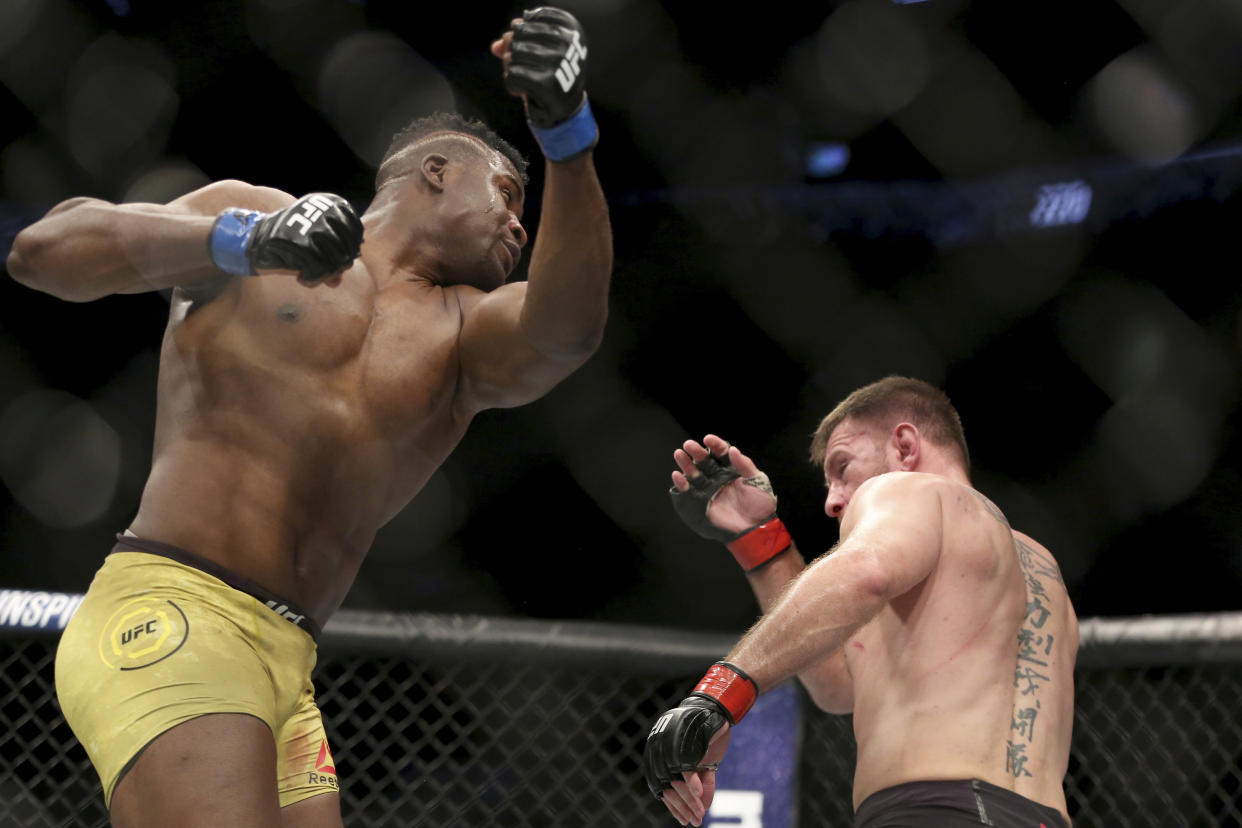 Francis Ngannou misses with an uppercut against Stipe Miocic during a heavyweight championship mixed martial arts bout at UFC 220. (AP)