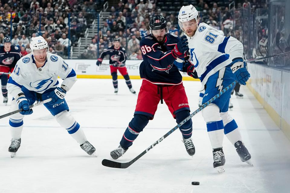 Nov 1, 2023; Columbus, Ohio, USA; Columbus Blue Jackets left wing Kirill Marchenko (86) fights for the puck with Tampa Bay Lightning defenseman Erik Cernak (81) during the first period of the NHL hockey game at Nationwide Arena.