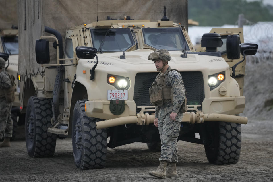 A U.S. Marine walks beside their vehicle during annual combat drills between the Philippine Marine Corps and U.S. Marine Corps in Capas, Tarlac province, northern Philippines, Thursday, Oct. 13, 2022. Truck-mounted launchers blasted off rockets Thursday and U.S. stealth fighter jets streaked across the northern Philippine sky in a combat drill and latest display of American firepower in a region where Washington has tried to deter what it warns as China's growing aggression. (AP Photo/Aaron Favila)