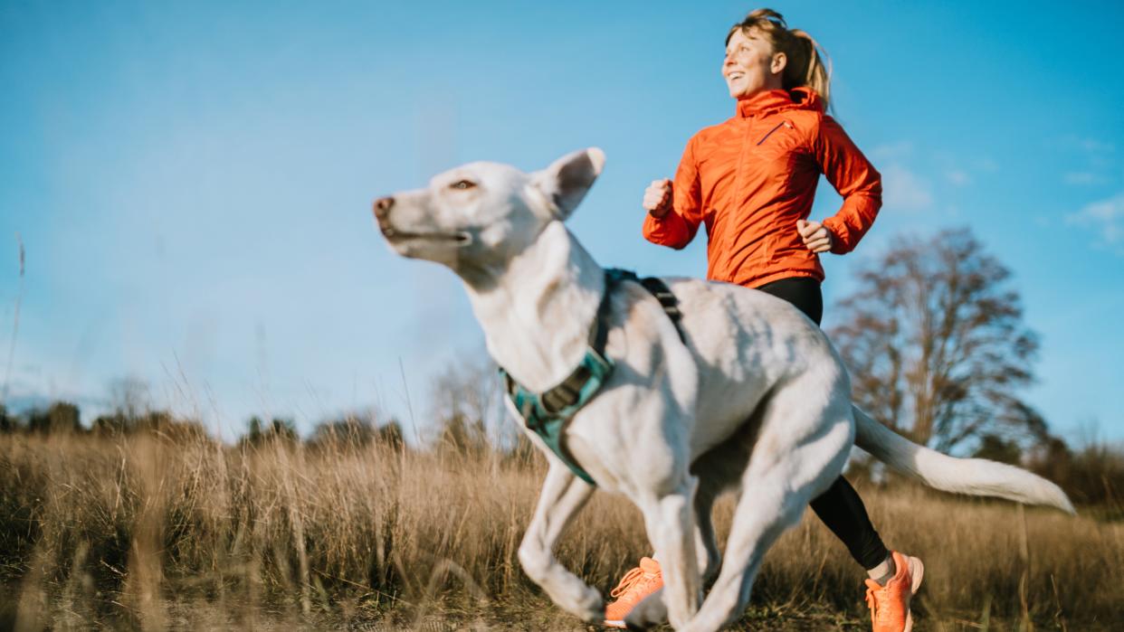 Woman running with dog