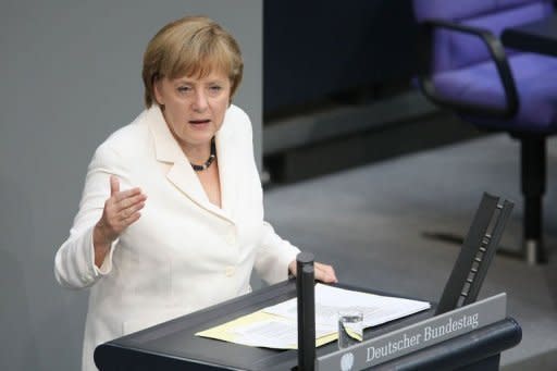 German Chancellor Angela Merkel addresses German lawmakers before they voted on the EU fiscal pact and permanent ESM bailout fund.The German parliament overwhelmingly approved two euro-crisis fighting tools Friday rallying to a call by Chancellor Angela Merkel to show the world Germany's commitment to the single currency