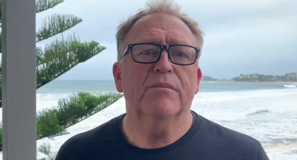 Pictured is Wamberal Beach resident Warren Hughes in front of the ocean.