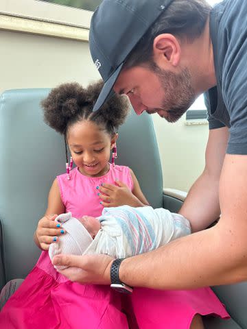 <p>Courtesy of Alexis Ohanian</p> Alexis Ohanian handing newborn daughter Adira to big sister Olympia