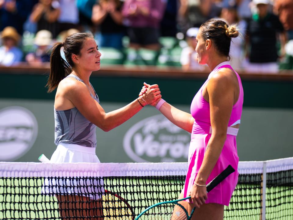 Emma Navarro shakes hands with Aryna Sabalenka after winning in the fourth round of the BNP Paribas Open in 2024.