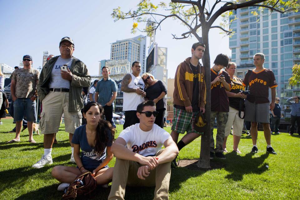 Fans look on at a makeshift memorial to former San Diego Padres outfielder Tony Gwynn at Petco Park in San Diego, California