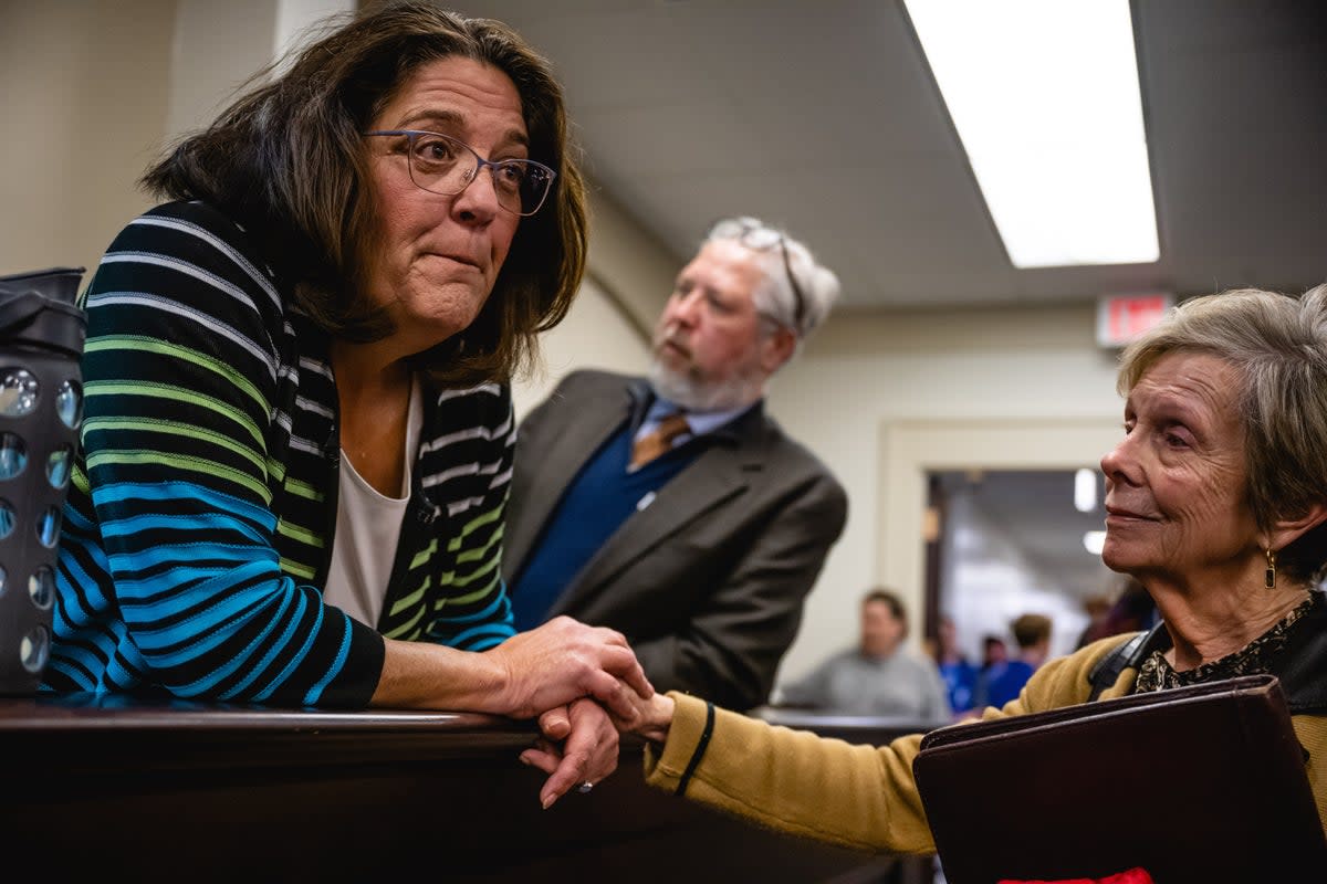 Kentucky state Senator Karen Berg, left, speaks with colleagues in supporters at the capitol in Frankfort following debate over sweeping anti-trans legislation on 14 March. (Getty Images)