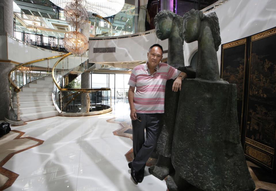 Cecil Chao, chairman of Hong Kong property developer Cheuk Nang Holdings, who has a reputation for being a playboy, poses in his house in Hong Kong Friday, Sept. 28, 2012. The daughter of the prominent Hong Kong tycoon who has offered $65 million to any man who can woo her away from her lesbian partner says she's not upset with her father. Gigi Chao says she’s on “very loving terms” with her father. He made world headlines this week when he offered the 500 million Hong Kong dollar marriage bounty after learning that his daughter had eloped with her partner to France. (AP Photo/Kin Cheung)