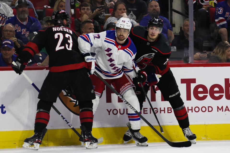 RALEIGH, NORTH CAROLINA - MAY 09: Filip Chytil #72 of the New York Rangers gets caught between Stefan Noesen #23 and Brady Skjei #76 of the Carolina Hurricanes in Game Three of the Second Round of the 2024 Stanley Cup Playoffs at PNC Arena on May 09, 2024 in Raleigh, North Carolina.