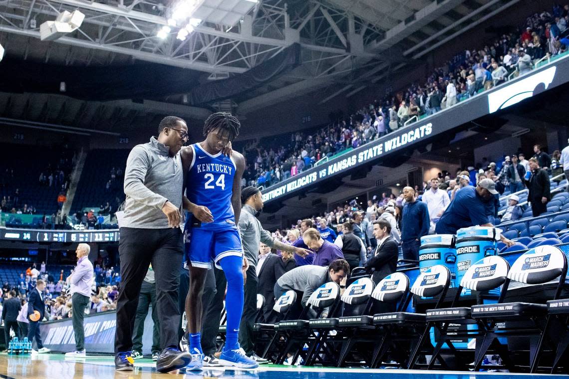 Kentucky freshman Chris Livingston walks off the court with assistant coach Chin Coleman after an NCAA Tournament loss to Kansas State on Sunday.