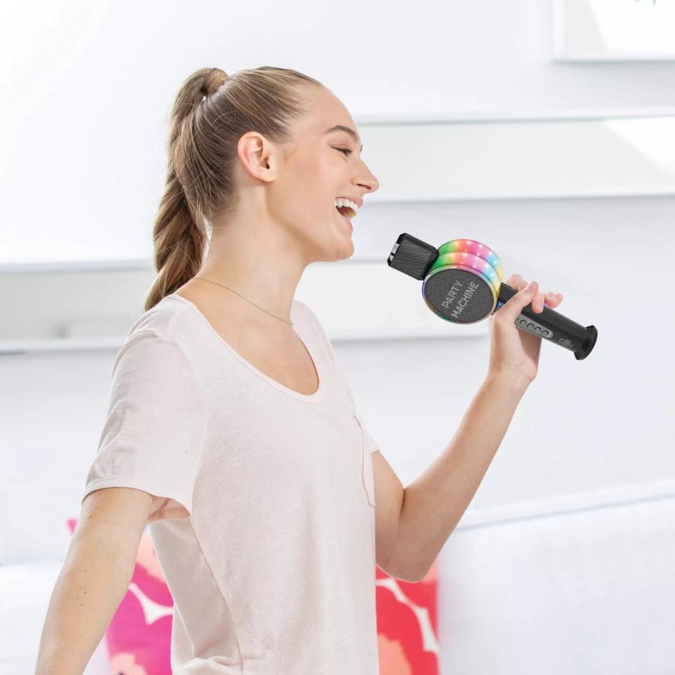 A model holding the mic, which has rainbow lights on the side