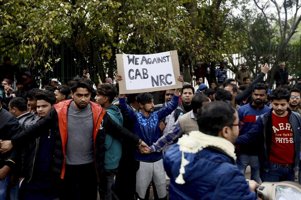 Indian students of the Jamia Millia Islamia University shout slogans during a protest in New Delhi, India, Monday, Dec.16, 2019. Thousands of university students flooded the streets of India's capital to protest a new law giving citizenship to non-Muslims who entered India illegally to flee religious persecution in several neighboring countries. The protests followed a night of violent clashes between police and demonstrators at the University. (AP Photo/Manish Swarup)