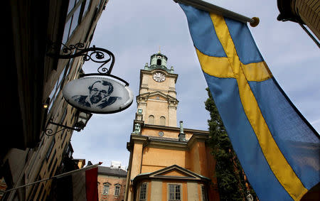 FILE PHOTO: Sweden's flag is seen near the Stockholm Cathedral in Gamla Stan or the Old Town district of Stockholm, Sweden, June 9, 2010. REUTERS/Bob Strong//File Photo