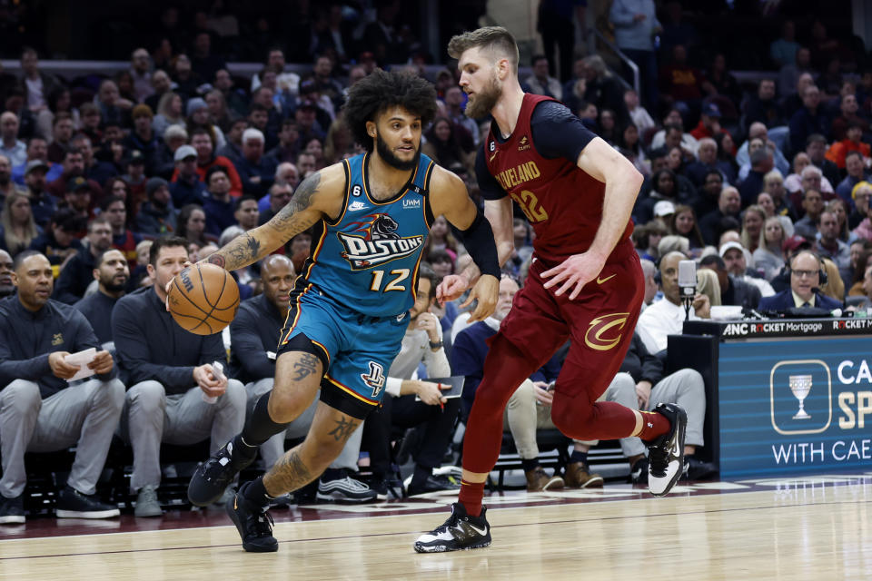 Detroit Pistons forward Isaiah Livers (12) drives against Cleveland Cavaliers forward Dean Wade (32) during the first half of an NBA basketball game, Wednesday, Feb. 8, 2023, in Cleveland. (AP Photo/Ron Schwane)