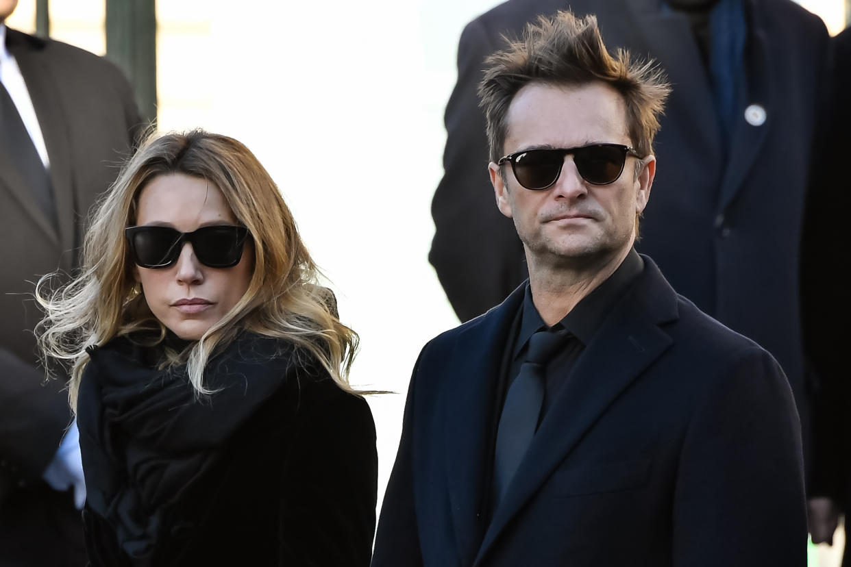 Son of late French singer Johnny Hallyday David Hallyday and daughter Laura Smet stand outside La Madeleine Church at the end of the funeral ceremony in tribute to late French singer Johnny Hallyday on December 9, 2017 in Paris.  French music icon Johnny Hallyday died on December 6, 2017 aged 74 after a battle with lung cancer, plunging the country into mourning for a national treasure whose soft rock lit up the lives of three generations.   / AFP PHOTO / BERTRAND GUAY        (Photo credit should read BERTRAND GUAY/AFP/Getty Images)