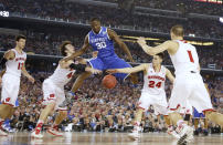 Kentucky forward Julius Randle (30) loses the ball as Wisconsin forward Frank Kaminsky (44), guard Bronson Koenig (24) and Ben Brust (1) defend during the first half of the NCAA Final Four tournament college basketball semifinal game Saturday, April 5, 2014, in Arlington, Texas. (AP Photo/Eric Gay)