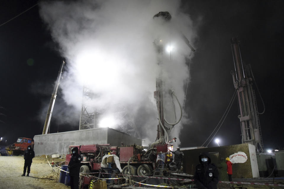 In this photo released by China's Xinhua News Agency, rescuers drill a new channel at the explosion site of a gold mine in Qixia City, east China's Shandong Province, Monday, Jan. 18, 2021. Chinese state media say 12 out of 22 workers trapped for a week by an explosion in the gold mine are alive, as hundreds of rescuers seek to bring them to safety. (Wang Kai/Xinhua via AP)