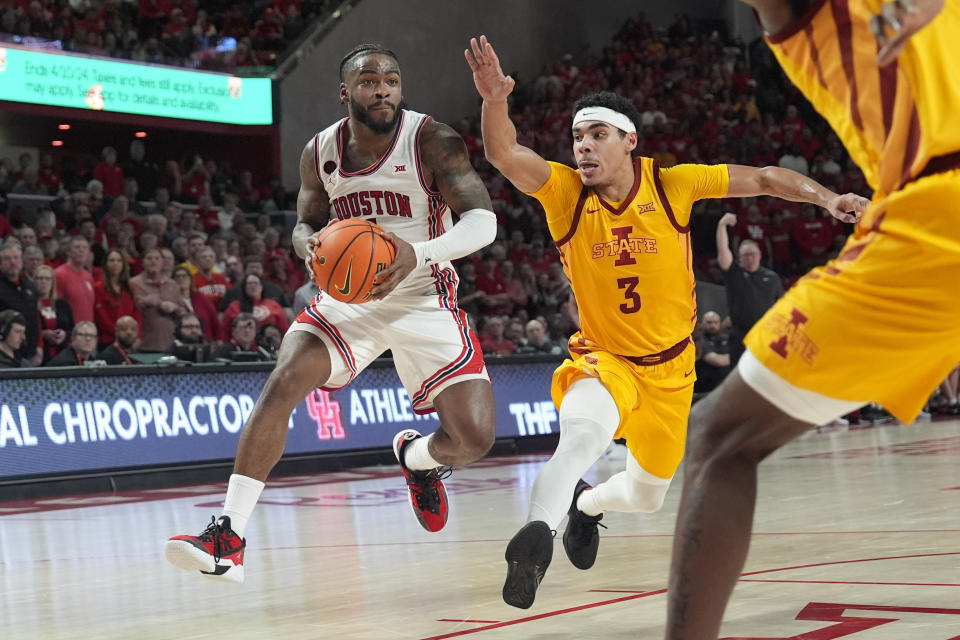 Houston's Jamal Shead, left, drives toward the basket as Iowa State's Tamin Lipsey (3) defends during the second half of an NCAA college basketball game Monday, Feb. 19, 2024, in Houston. Houston won 73-65. (AP Photo/David J. Phillip)