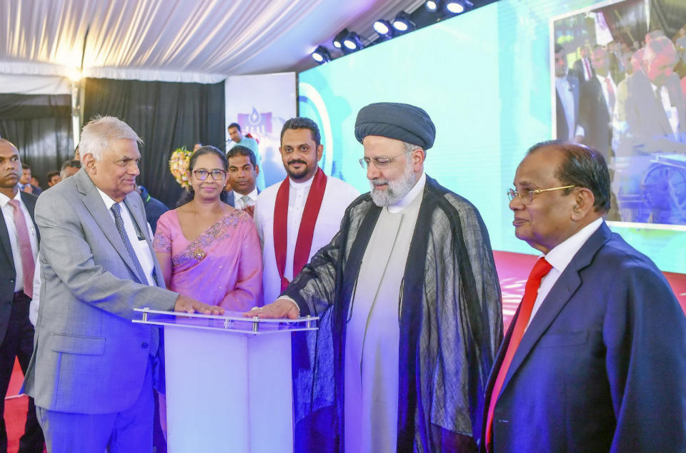 Iranian President Ebrahim Raisi, second right, and Sri Lankan President Ranil Wickremesinghe, in a grey suit, inaugurate the Uma Oya Multipurpose Development Project in Uma Oya , about 180km (112miles) east of Colombo, Sri Lanka, Wednesday, April 24, 2024. The project was scheduled for completion in 2015 but was delayed by the sanctions, technical issues and the COVID-19 pandemic, the Sri Lankan government said. (Sri Lanka President's Office via AP)