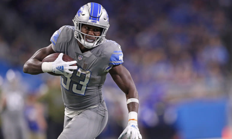 A closeup of Kerryon Johnson running with the football.