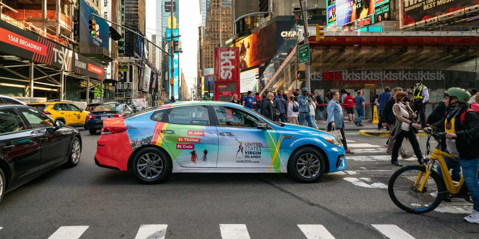 A vehicle wrapped with an advertisement in New York City.