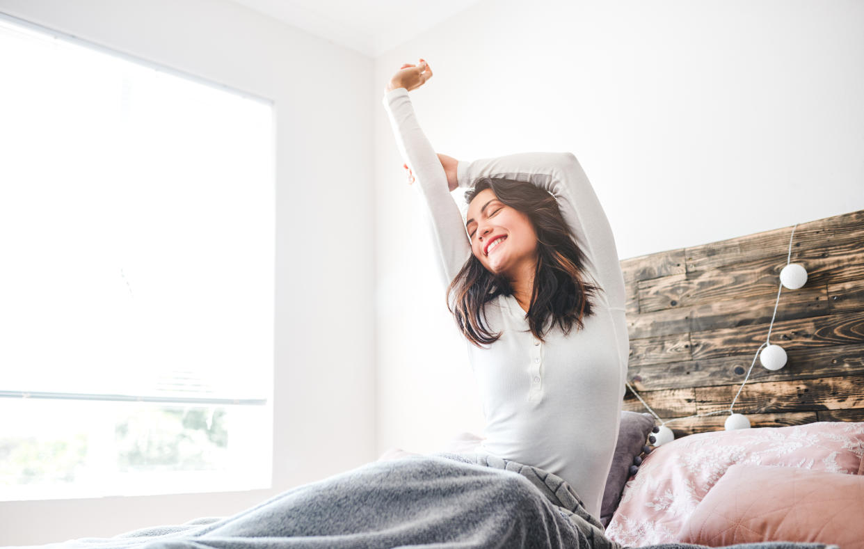 Woman waking up from a good night's sleep. (Getty Images)