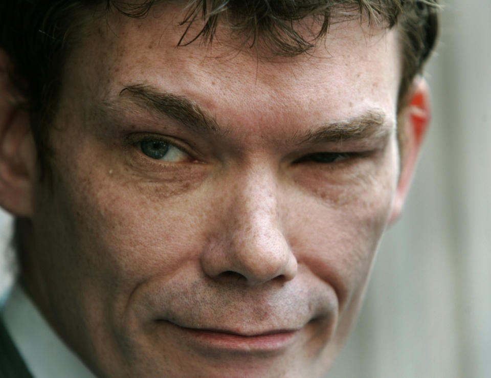 FILE - In this Wednesday May 10, 2006 file photo Gary McKinnon, accused of mounting the largest ever hack of United States government computer networks, listens to a reporter's question outside the Bow Magistrates Court in central London. Britain's Home Secretary is set to rule on Tuesday Oct. 16, 2012, whether to extradite a British hacker to America to face charges for breaking into sensitive computer networks at U.S. military and space installations. (AP Photo/Lefteris Pitarakis, file)