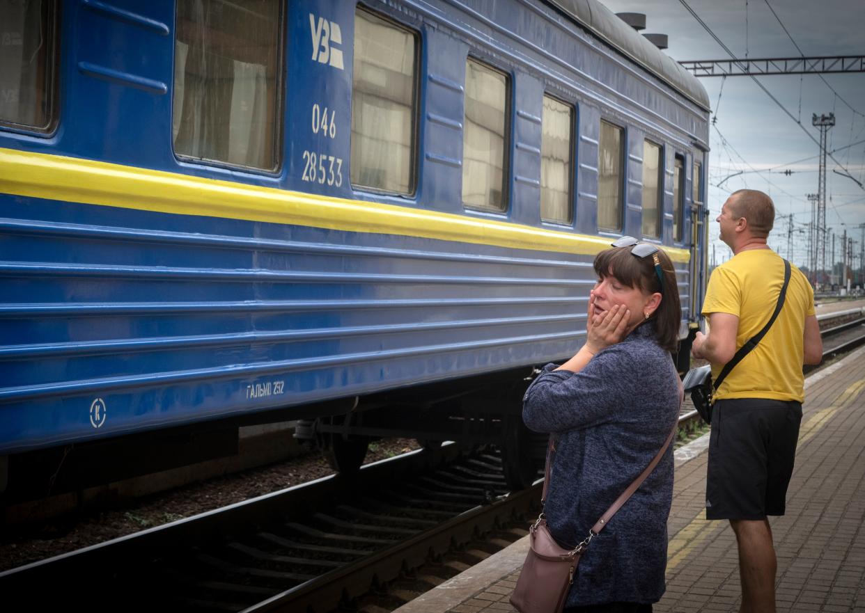A woman reacts as she watches an evacuation leave at a railway station in Pokrovsk, eastern Ukraine.