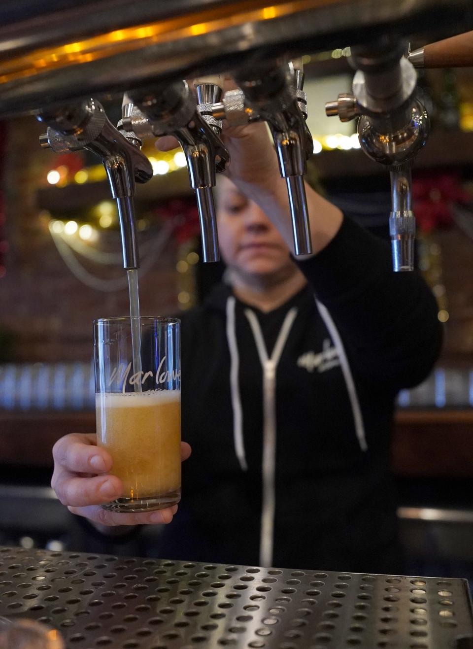 Carla Waclawski pulls on a tap at Marlowe Artisanal Ales in Nyack on Wednesday, November 30, 2022.