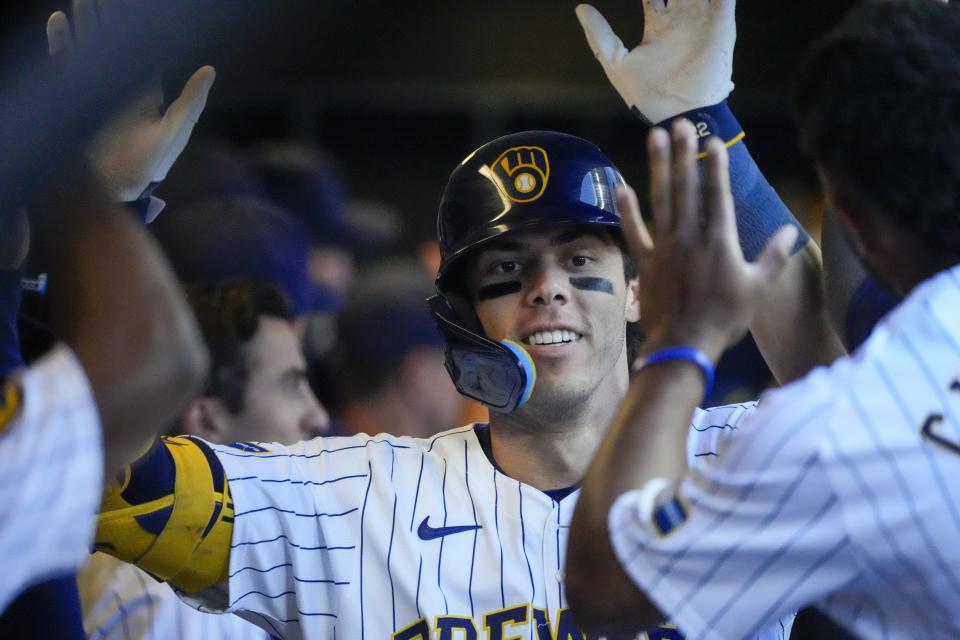 Milwaukee Brewers' Christian Yelich is congratulated after hitting a home run during the fourth inning of a baseball game against the Chicago Cubs Sunday, June 30, 2024, in Milwaukee. (AP Photo/Morry Gash)