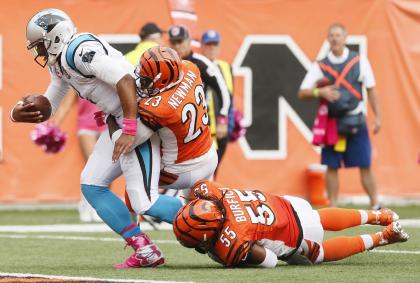 Vontaze Burfict (55) has the leg of Cam Newton as the Panthers QB finishes a 12-yard touchdown run. (AP)