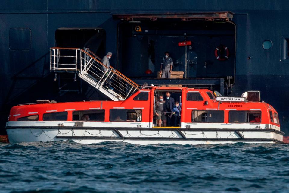 Passengers of Holland America's cruise ship Zaandam are transferred to the Rotterdam cruise ship in Panama City bay on March 28,2020.  Panama's maritime authority said healthy passengers were being evacuated from the Zaandam to another liner, the Rotterdam. 