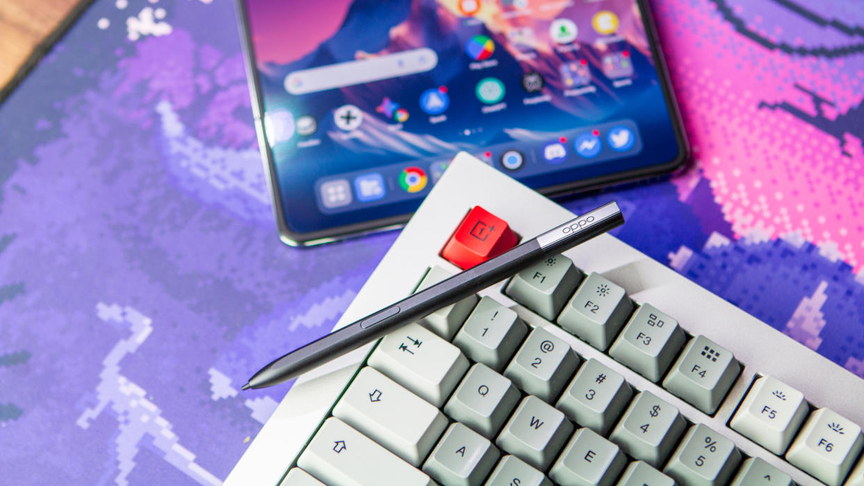  Oppo Pen on OnePlus keyboard with OnePlus Open in the background. 